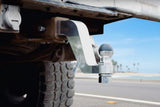 Andersen Hitches Alumistinger on the back of a pickup truck with tropical backround.