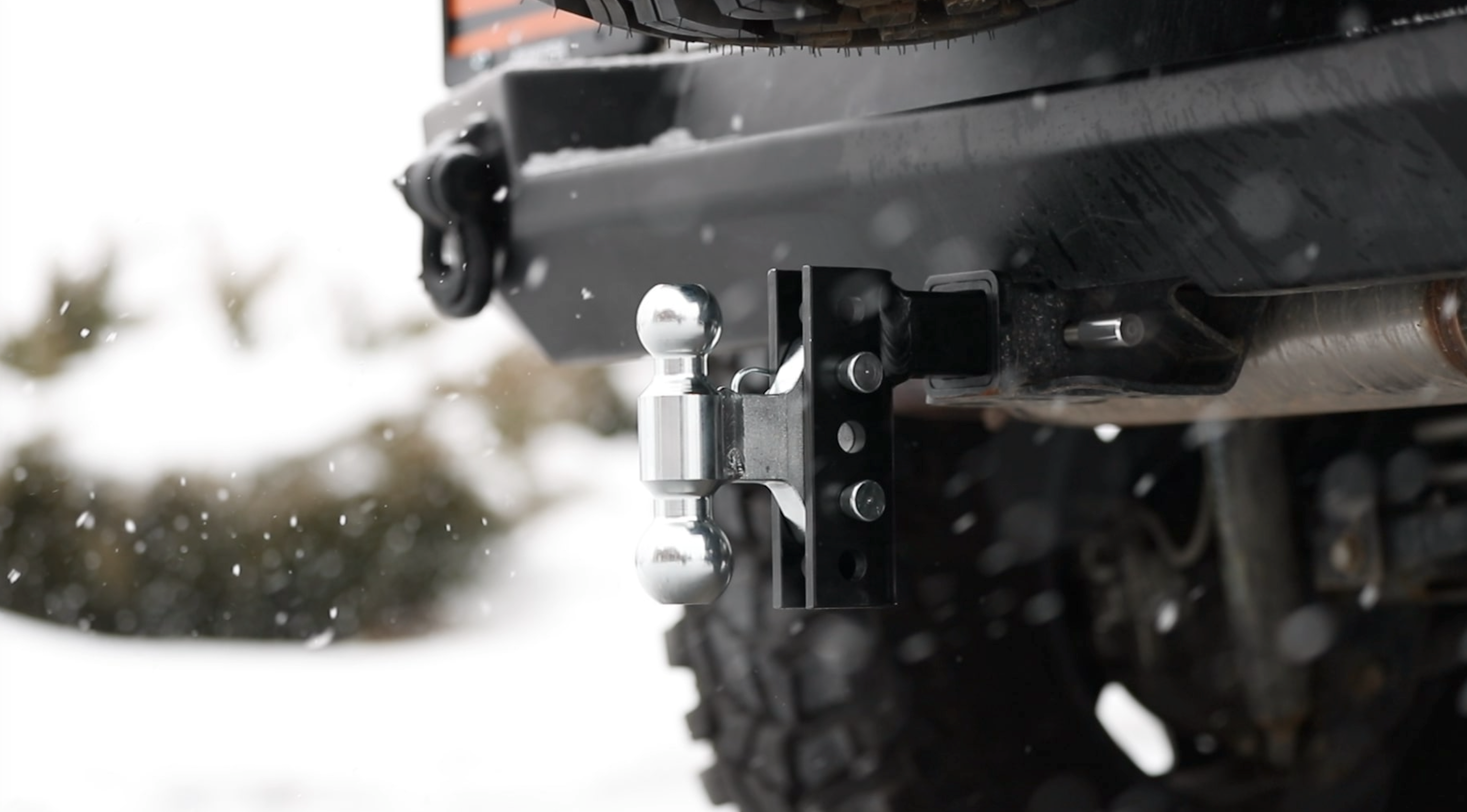Andersen EZ Hitch ball mount installed on a truck in winter snow, ready for towing.