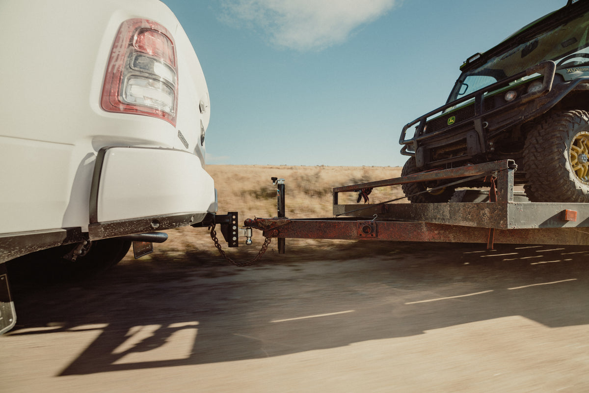 Andersen Hitches Rapid Hitching pulling a trailer with a John Deere 4x4 on it.