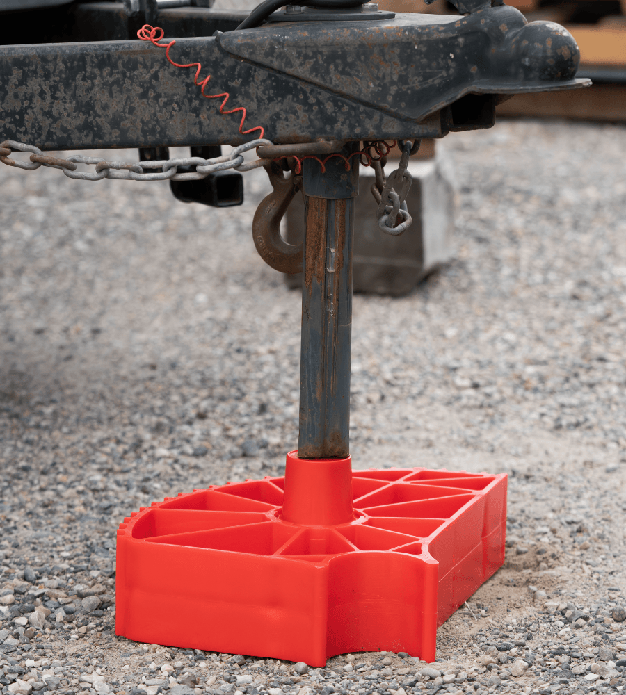 Another angle of the Single Axle Rapid Jack (S.A.R.J) flat on the ground with a trailer post jacked lowered onto the secured chock.