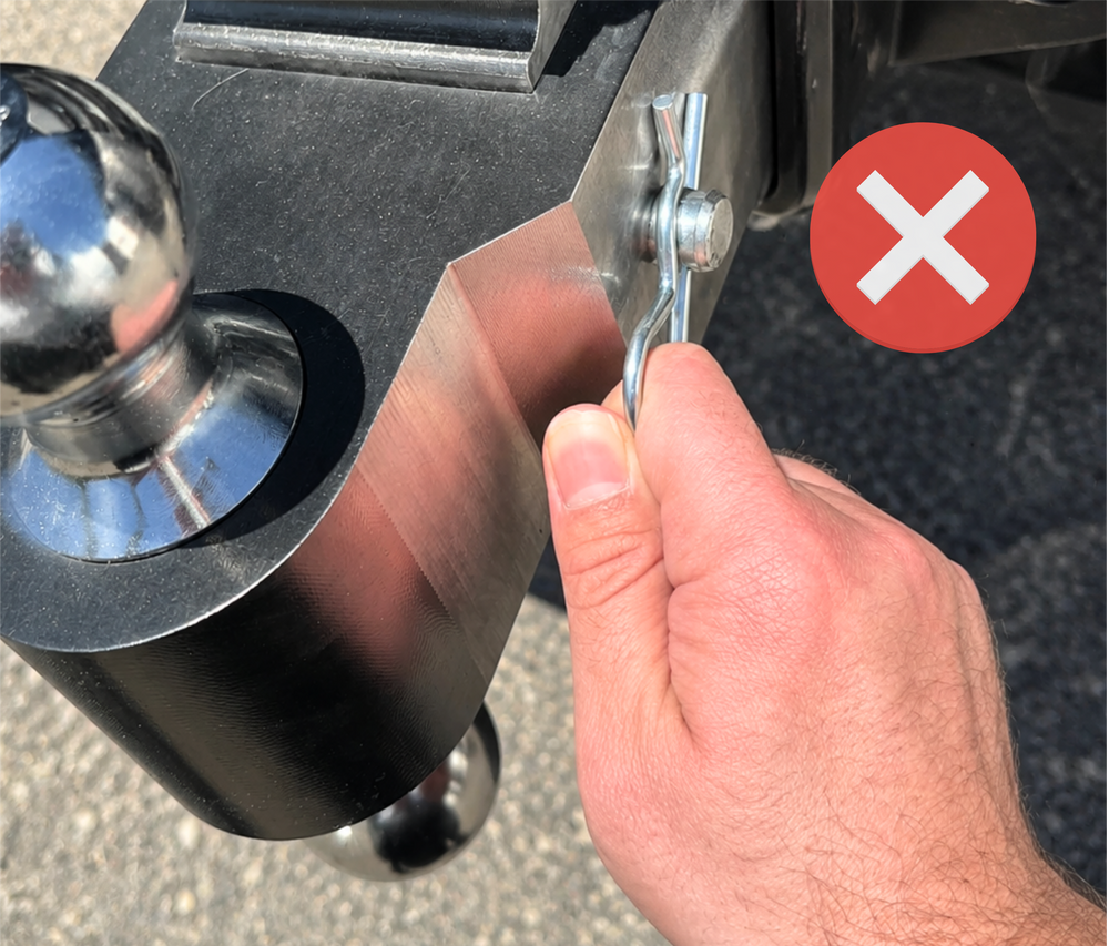 Rusty standard hitch pin with hairpin clip — the old way of swapping trailer balls