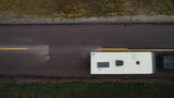 Andersen Hitches Weight Distribution Hitch promotional video featuring an anti-sway, load-leveling towing system for RVs and trailers. The video highlights a 16,000 lb GTWR capacity and demonstrates how the unique friction cone design and bounce-dampening chain system provide superior sway control compared to traditional rigid sway bars. Visuals show a GMC heavy-duty truck towing a large travel trailer on paved roads and off-road terrain, emphasizing improved braking, handling, and stability.