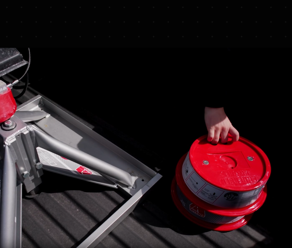Lifestyle footage of a grey truck hauling a trailer into a desert setting for dirt biking. The video showcases the ease of using Andersen Trailer Jack Blocks to stabilize an RV, allowing more time for outdoor adventures.